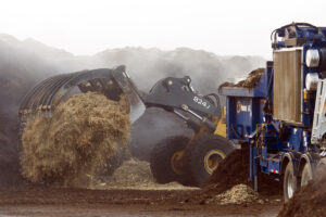 Wood waste being moved by equipment at Environmental Wood Supply in Saint Paul