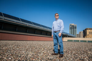 Engineer in front of solar thermal panels in Saint Paul